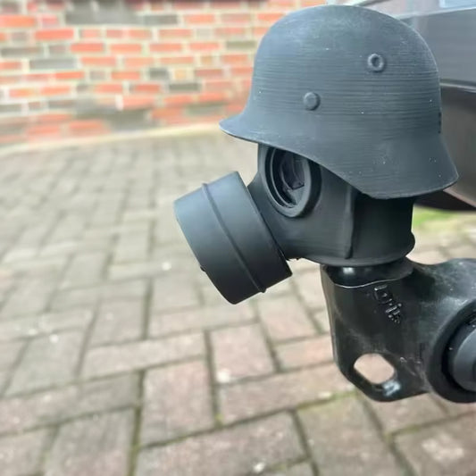 3D - printed trailer hitch cover with steel helmet and gas mask design. Protects the receiver tube from rusting.